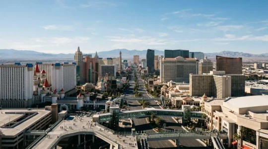 Aerial view of the Las Vegas Strip featuring elevated pedestrian walkways connecting major casino resorts under bright Nevada sunlight