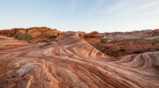 Fire Wave formation with flowing red, pink, and white sandstone stripes in Valley of Fire State Park, Nevada