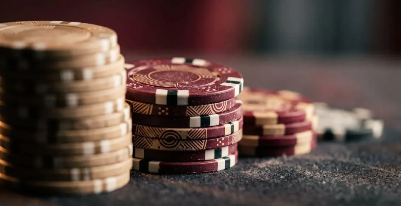 Extreme close-up macro shot of casino chips stacked in decreasing progression showing bankroll depletion concept