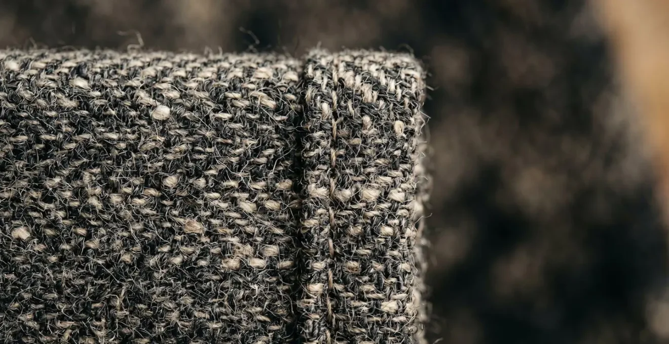 Close-up macro detail of fabric texture and garment construction showing quality stitching