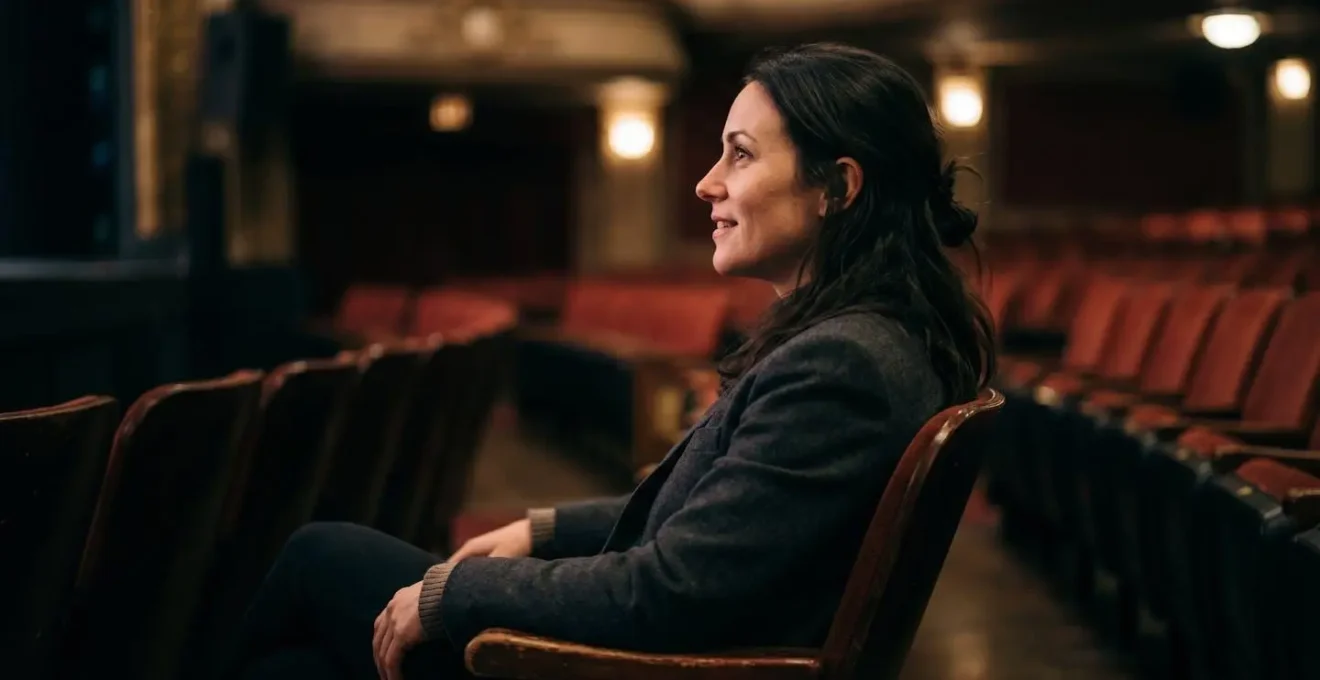 Theater audience member displaying engaged and receptive body language without being overly enthusiastic