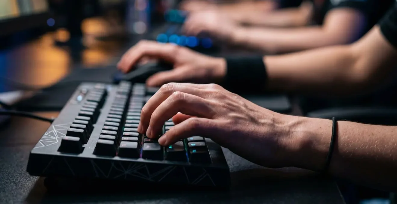 Close-up of competitive gamer's hands on gaming peripherals during an intense esports tournament match