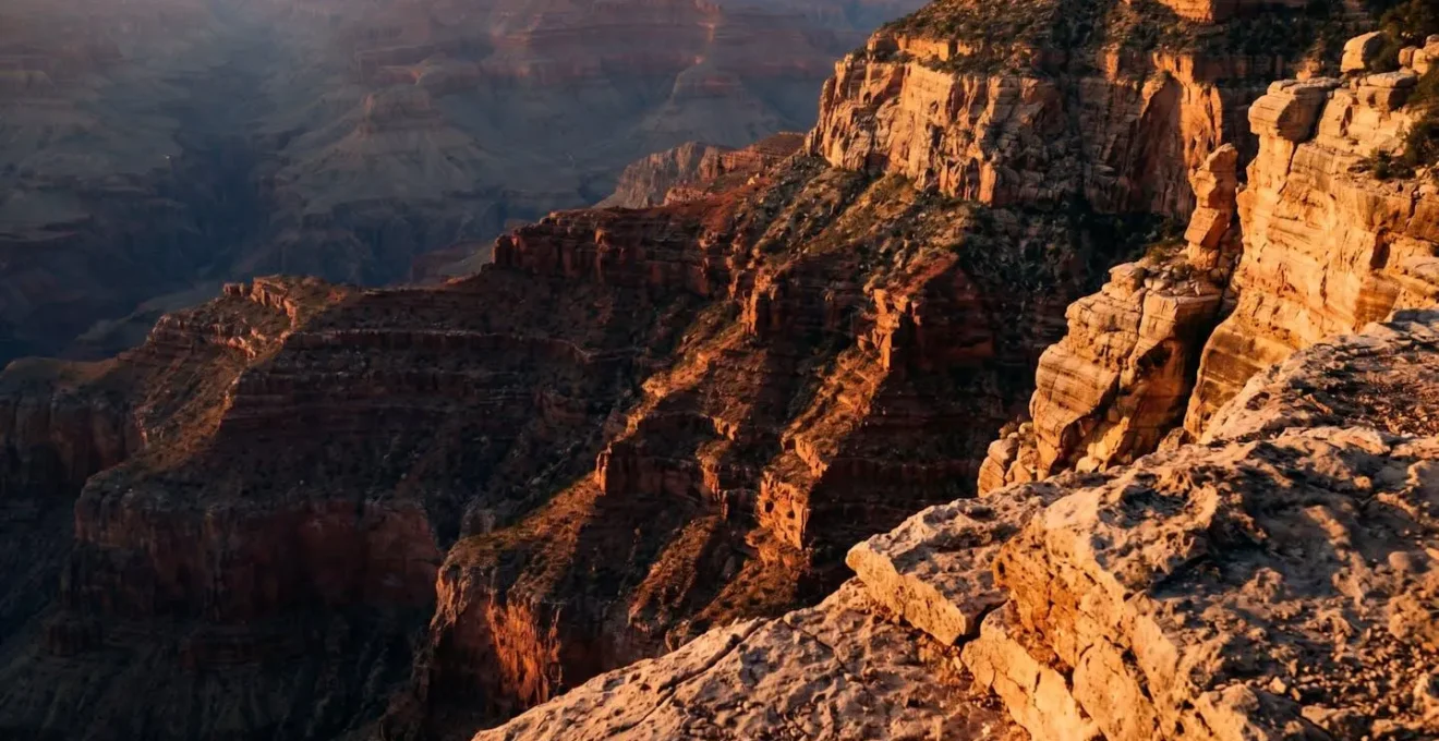Grand Canyon West Rim at golden hour with dramatic long shadows emphasizing the layered rock formations and deep texture of the canyon walls