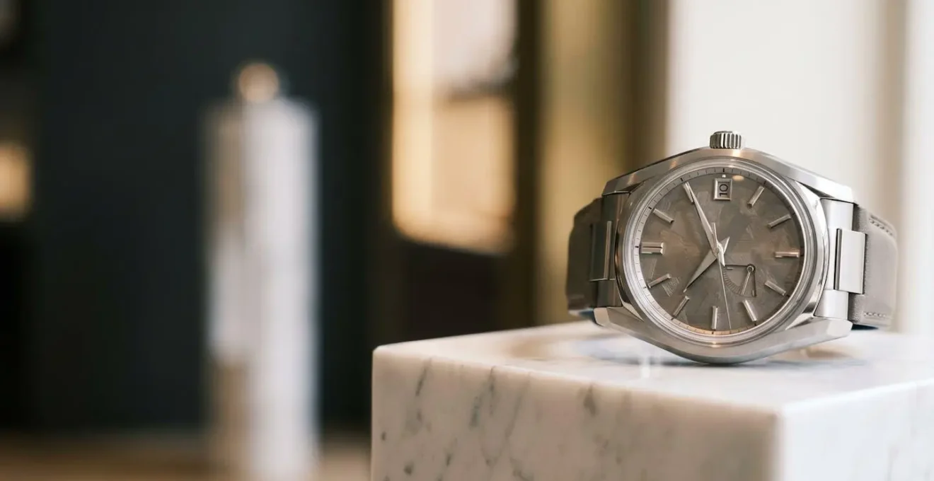 Elegant luxury timepiece presented on sophisticated display in refined boutique setting