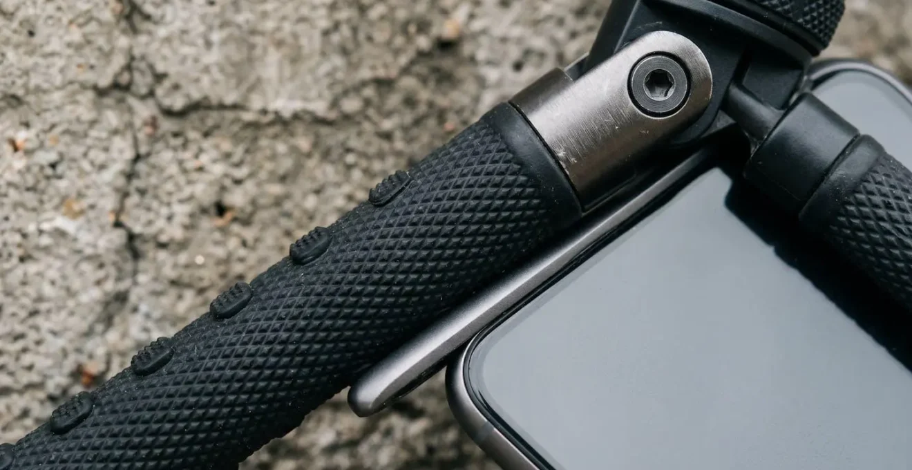 Macro close-up of flexible smartphone tripod gripping device against textured concrete surface